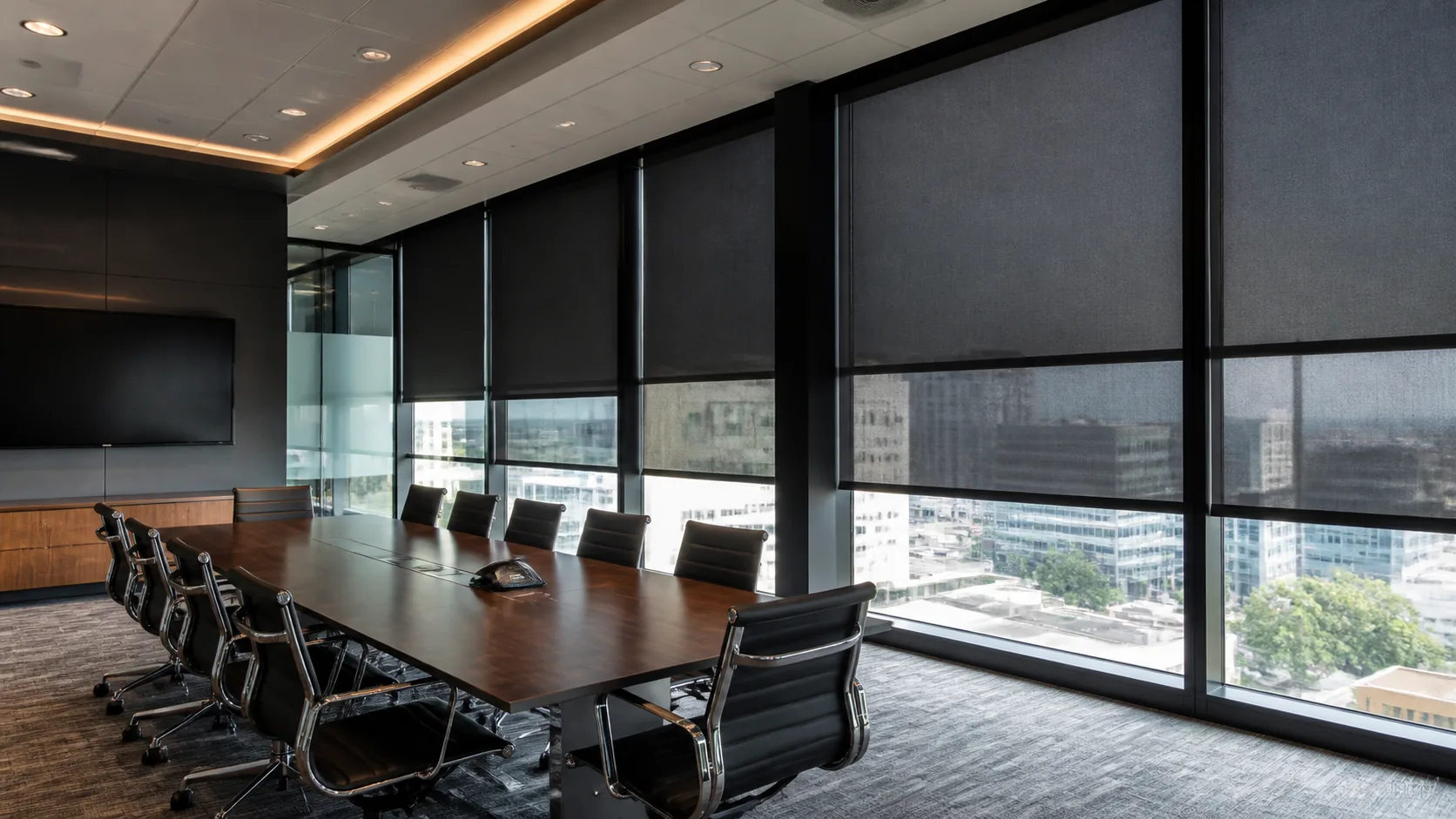 Commercial conference room fitted with dark blackout roller shades