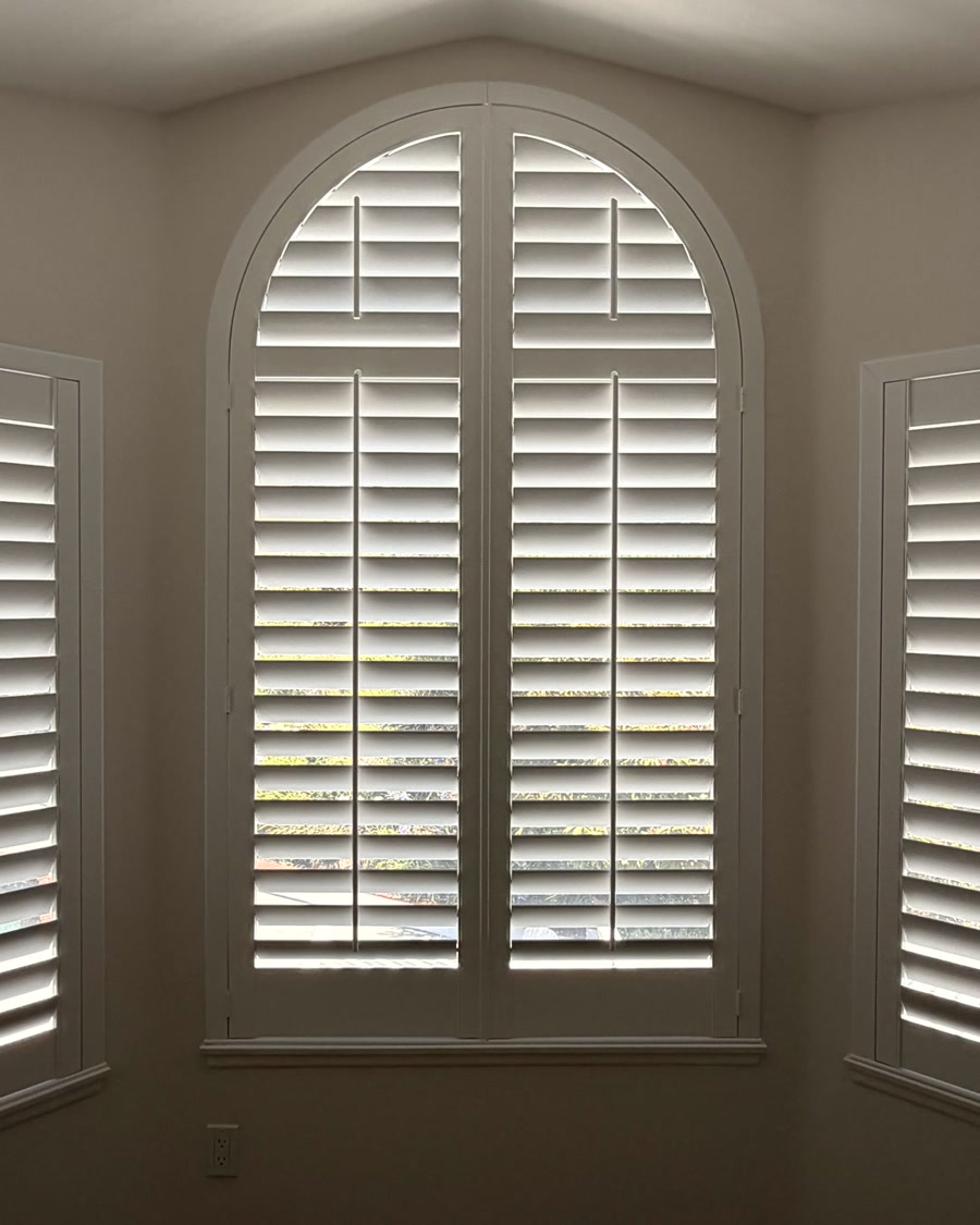 Custom arched plantation shutters with side bedroom shutters in Ventura County