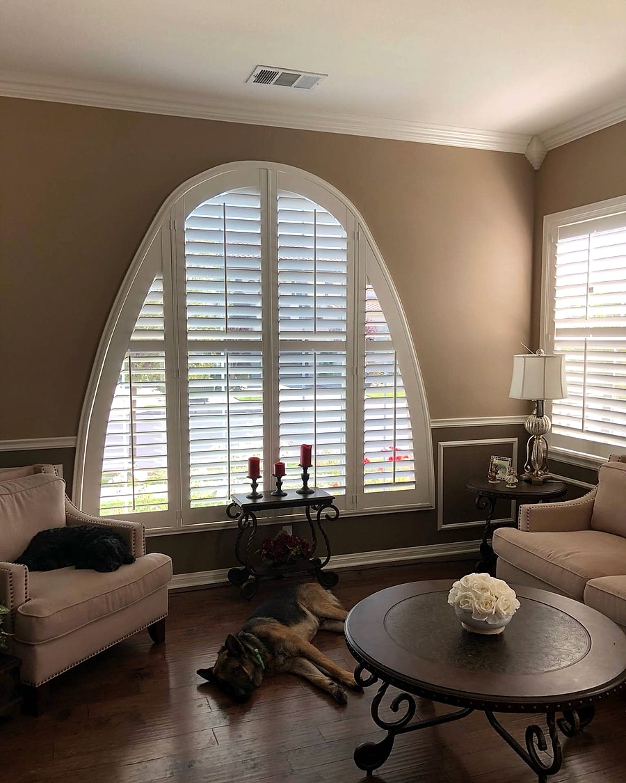 Custom arched plantation shutters in a Ventura County living room installed by 805 Shutters Shades and Blinds.