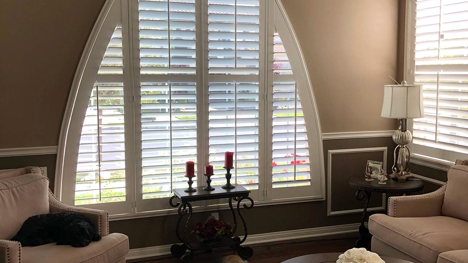 Custom arched plantation shutters in a Ventura County living room installed by 805 Shutters Shades and Blinds.