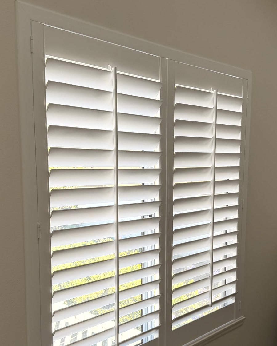 White plantation shutters installed on a Ventura County bedroom window