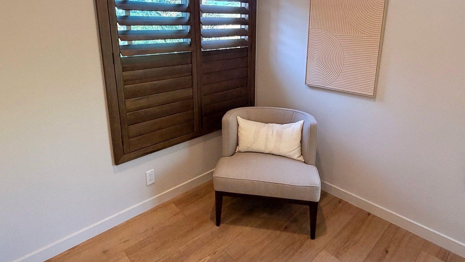 Dark wood plantation shutters in a Ventura County reading room installed by 805 Shutters Shades and Blinds.