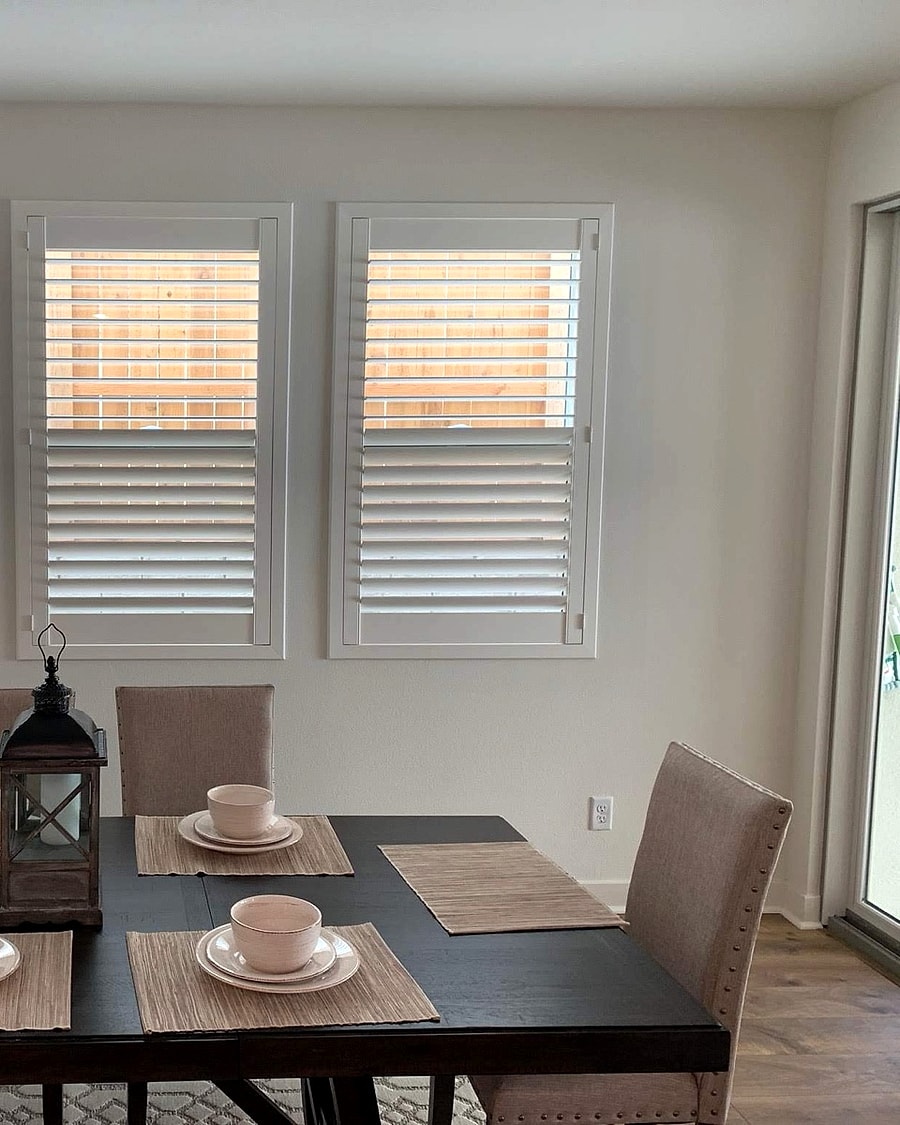 White plantation shutters in a Ventura County dining room installed by 805 Shutters Shades and Blinds.