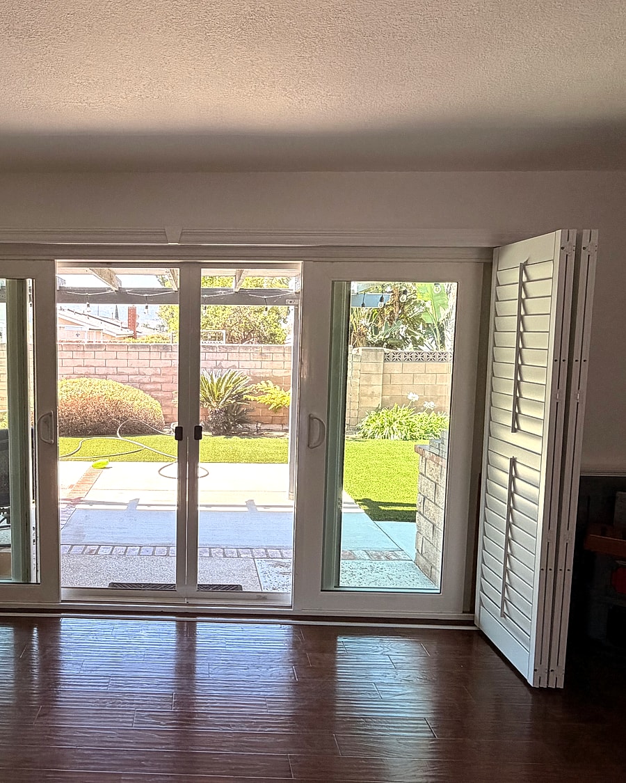 Plantation shutters installed around patio doors