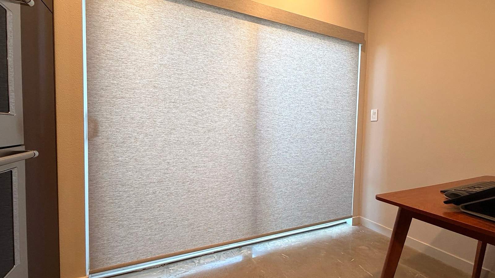 Roller shade covering a large Ventura County window installed by 805 Shutters Shades and Blinds.