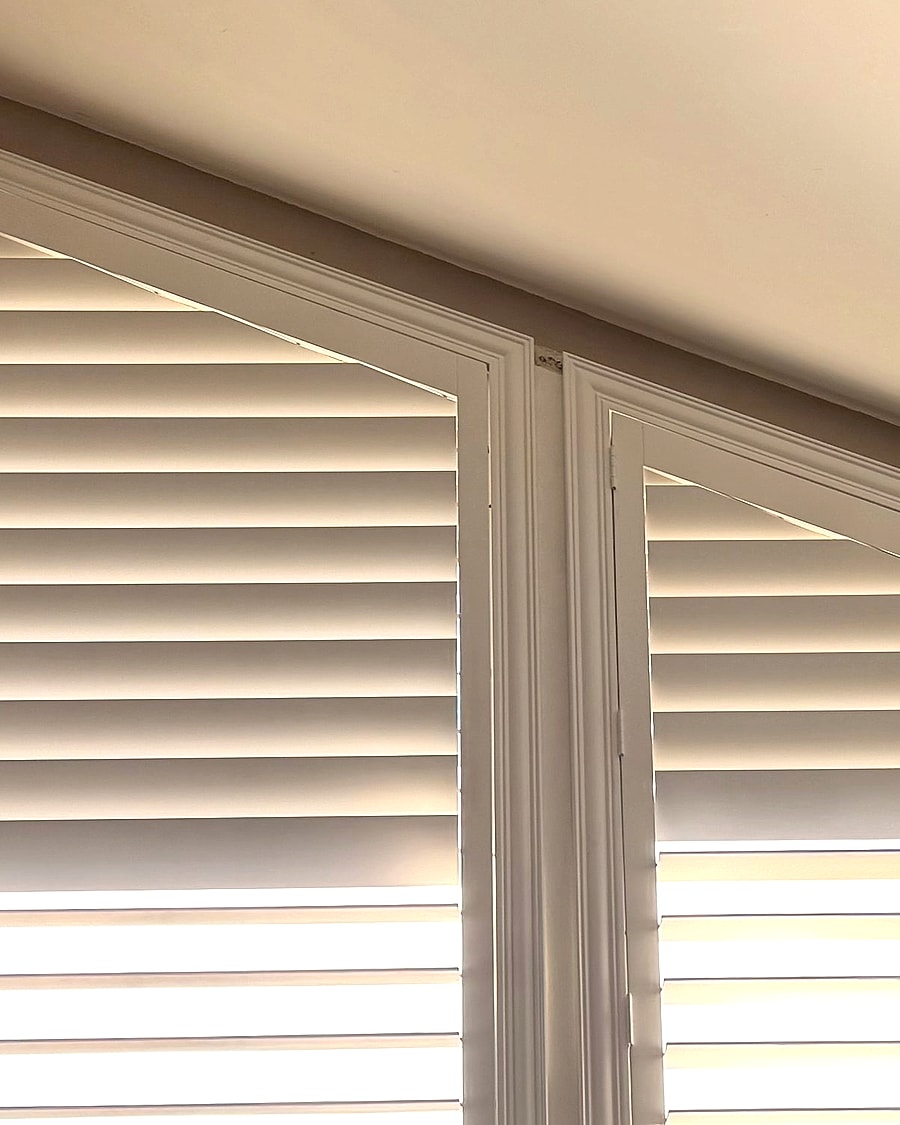 Custom plantation shutter detail on tall angled Ventura County windows