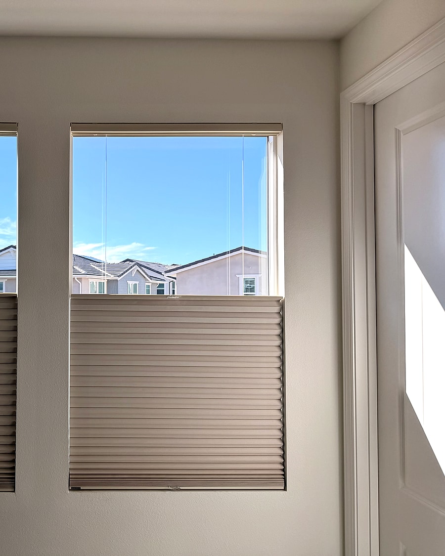 Twin cellular shades installed on side-by-side bedroom windows