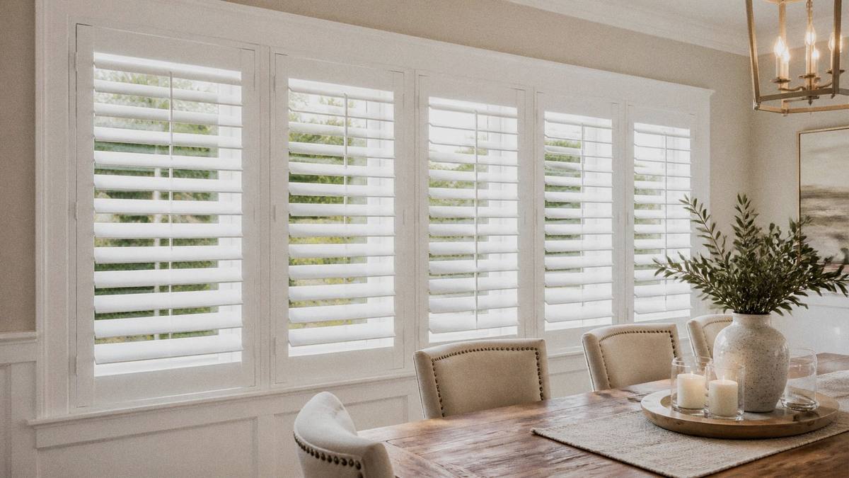 Painted white wood plantation shutters in a bright dining room