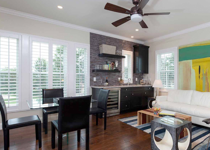 Living room with white shutters near Ventura, CA, sold and installed by 805 Shutters Shades & Blinds.